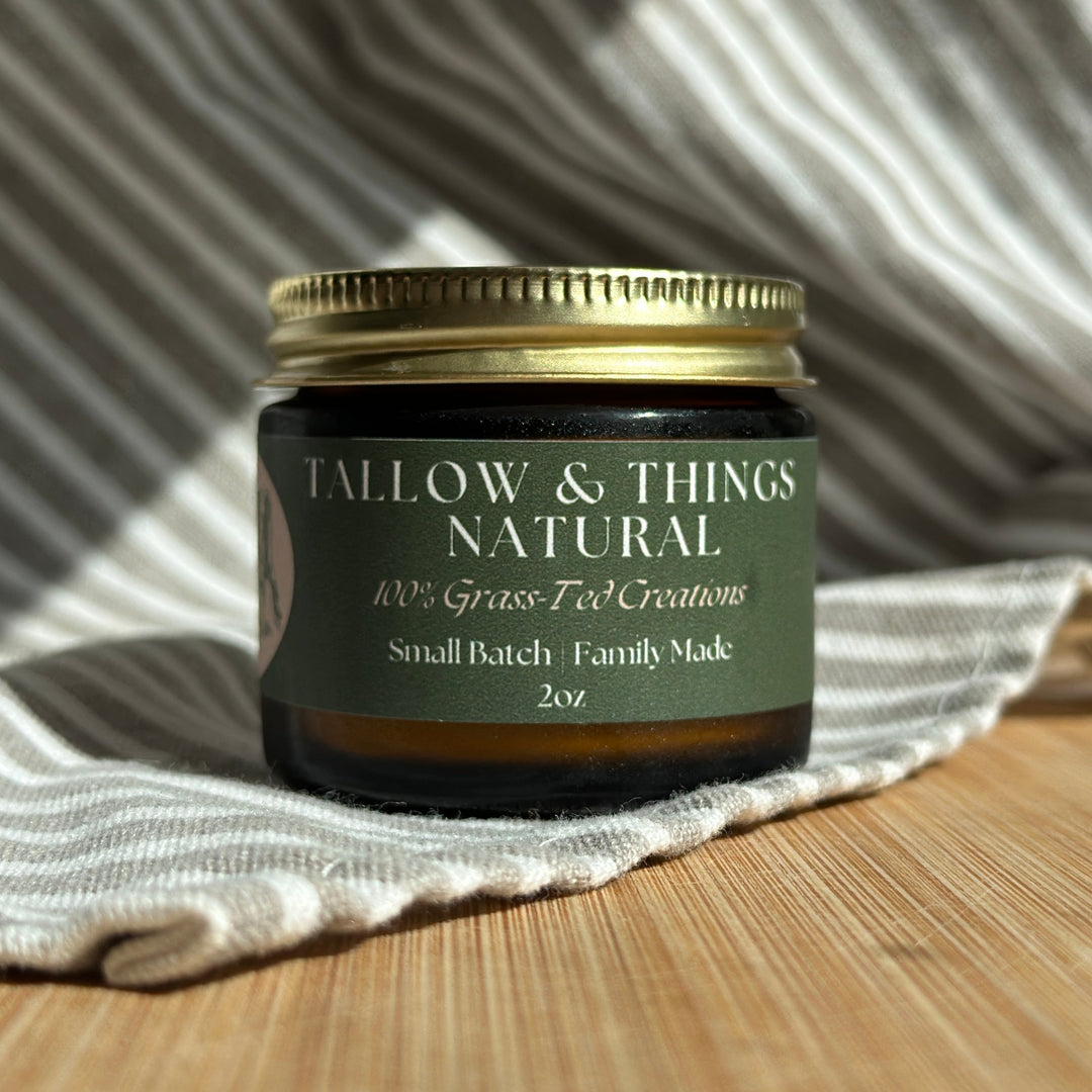 A jar of Naked tallow face moisturizer on a wooden surface with a white and striped fabric backdrop.