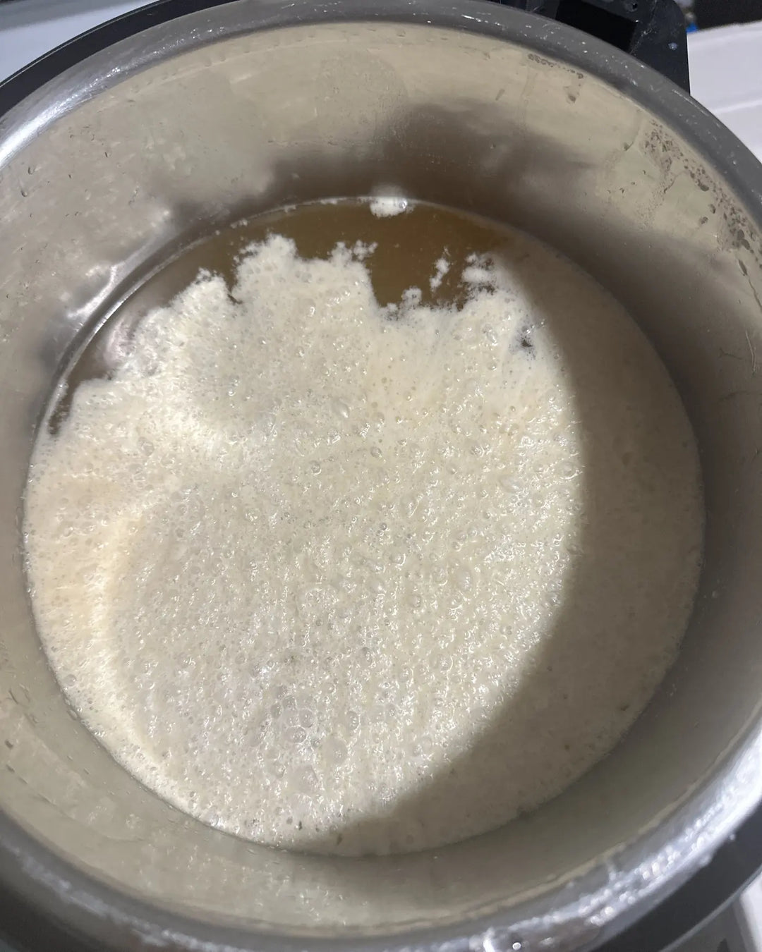 Beef tallow rendering in a pot during the small-batch purification process