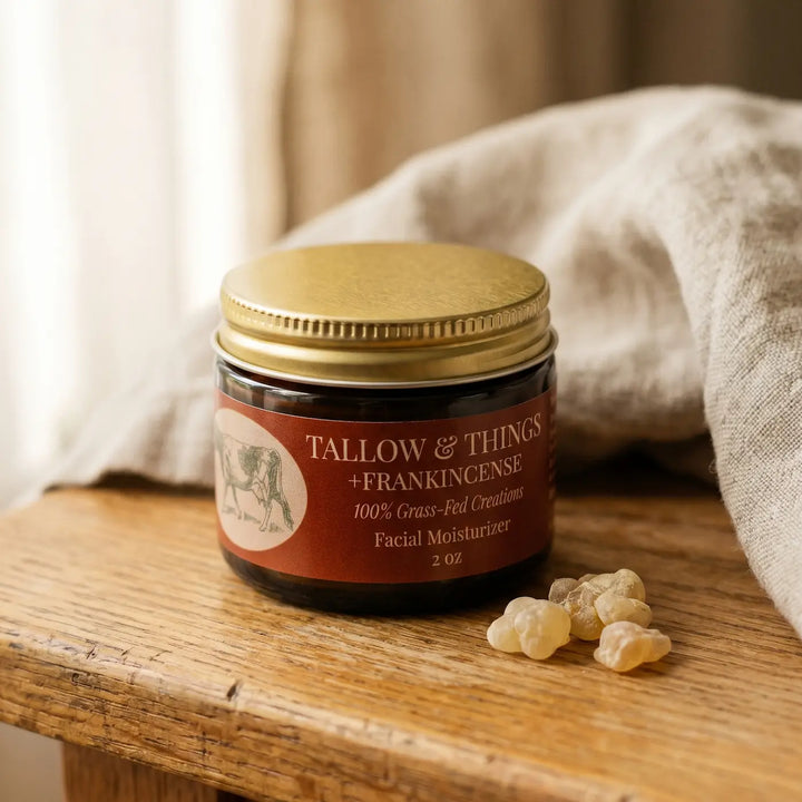 Frankincense tallow facial moisturizer jar with golden resin on a warm oak surface in soft window light.