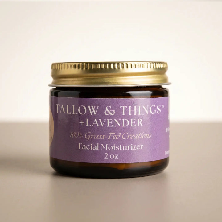 Lavender tallow facial moisturizer 2oz jar, front label, on a clean warm neutral background.