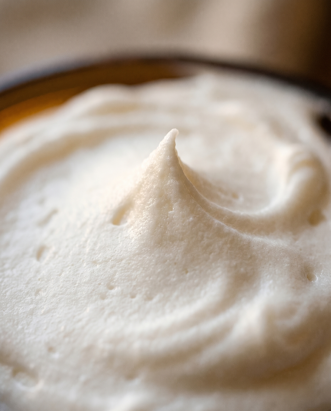 Macro of soft peaked whipped white tallow showing its airy cloud-like texture